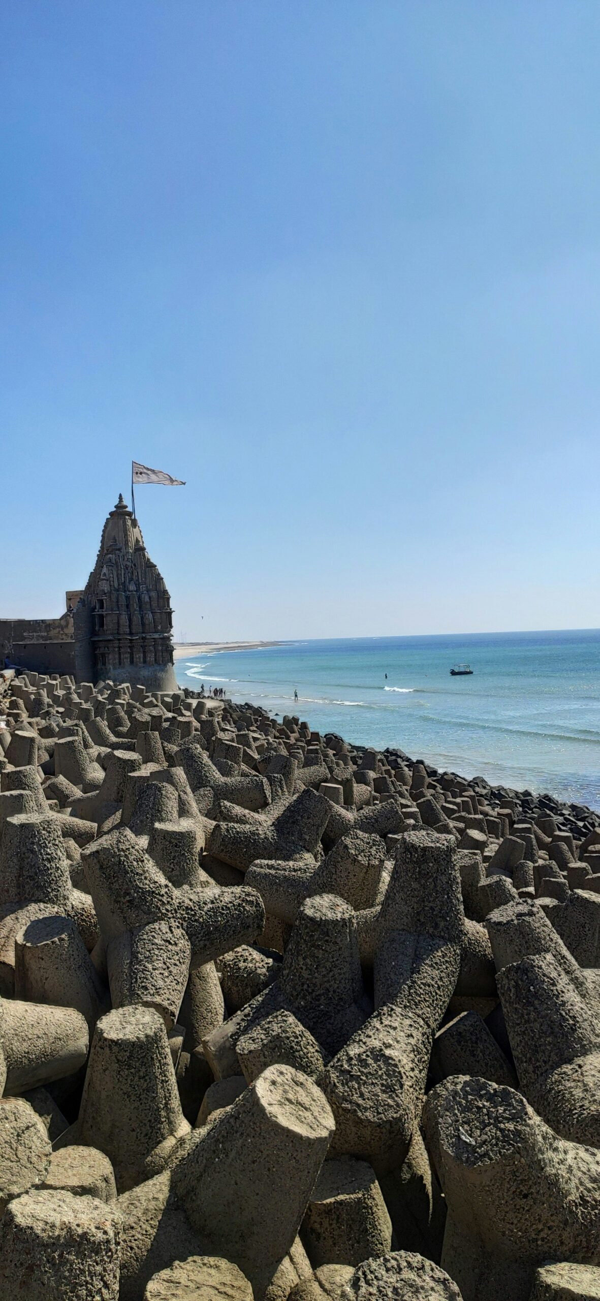 a large rock formation on a beach next to the ocean